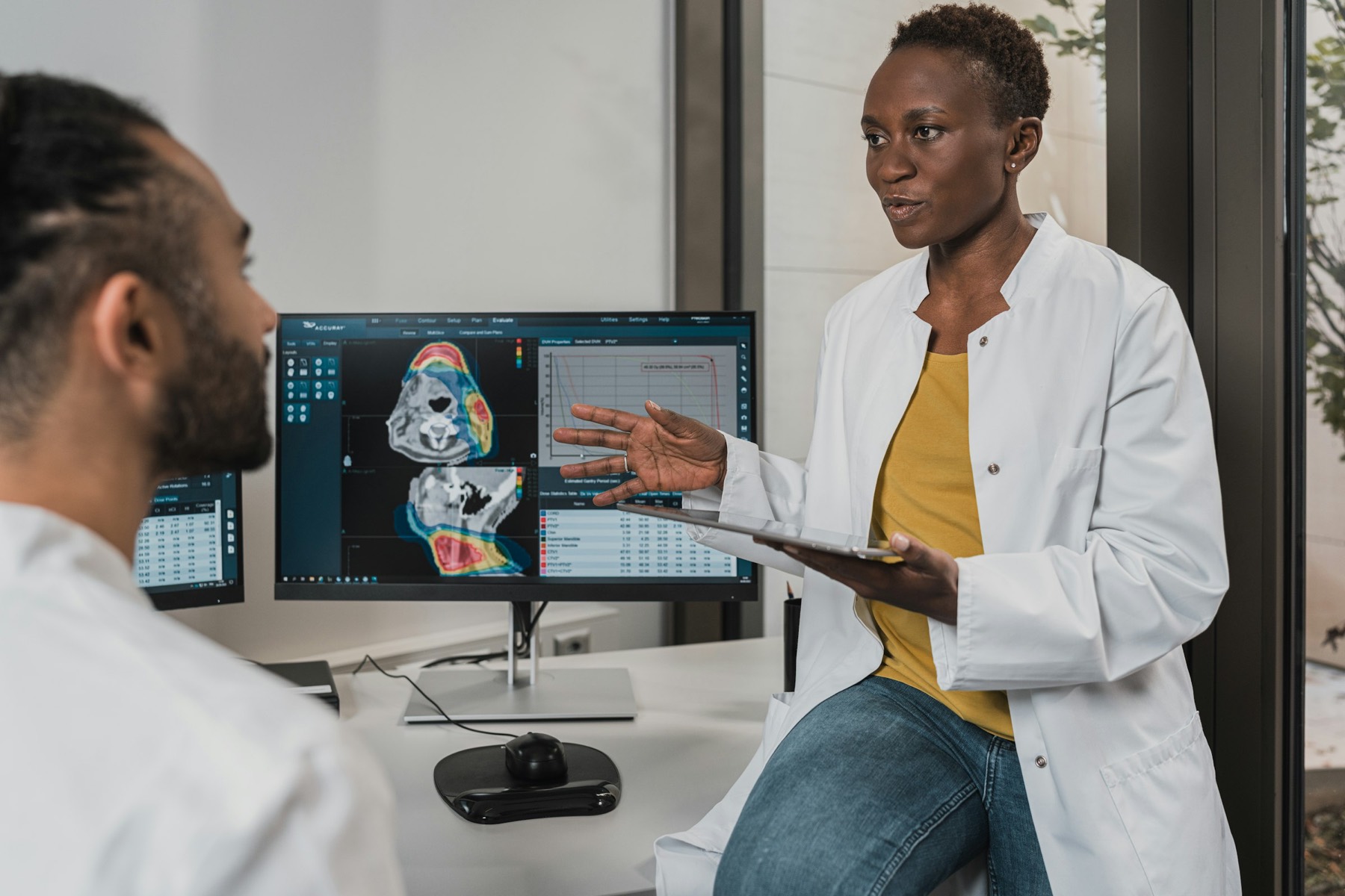 A clinician talking a patient through results in a bright consultation room