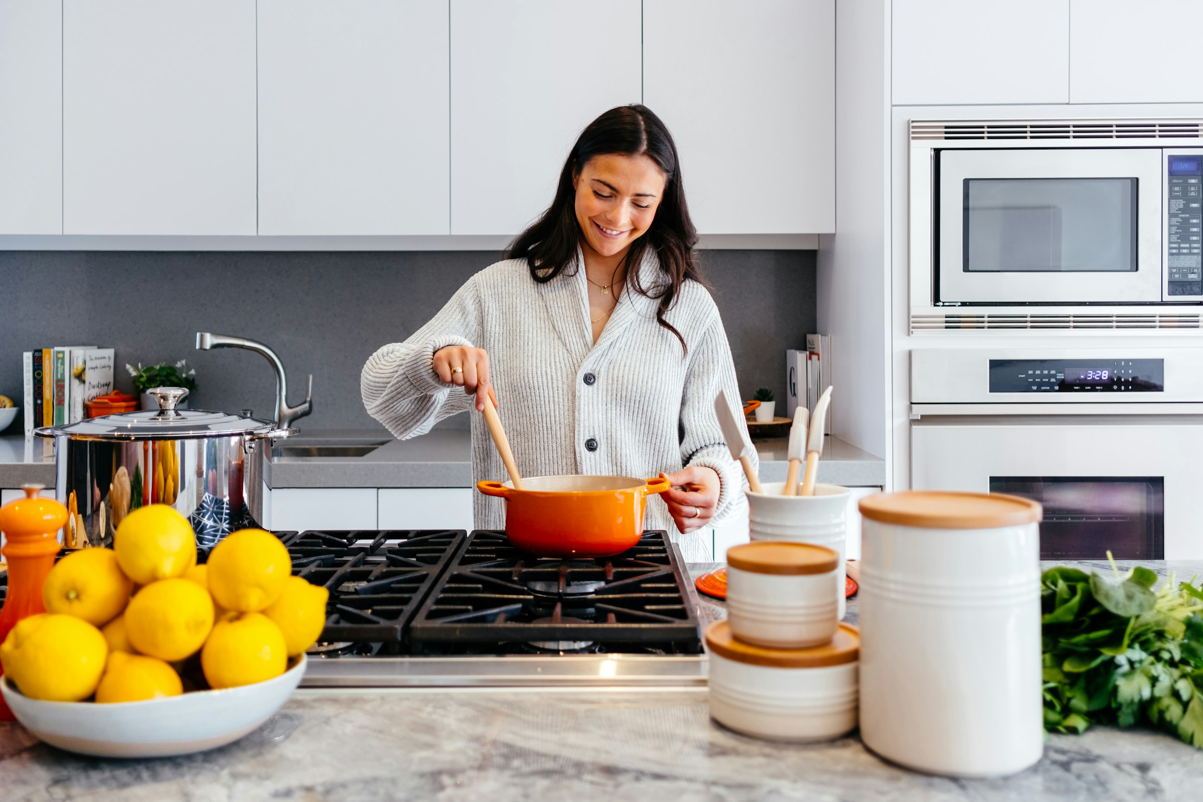 A homeowner cooking in a bright modern kitchen